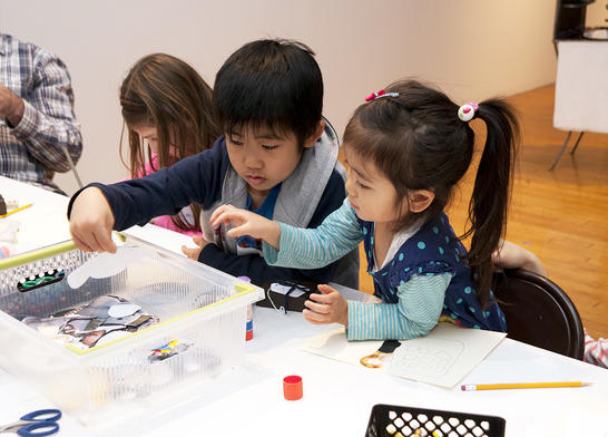 Two children making artwork.