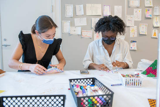 Two visitors making artwork in the MAAM Barkan Big Ideas Studio