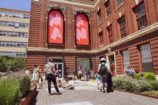 Visitors gathering outside the MassArt Art Museum enjoying art making and fun at Art on the Plaza!