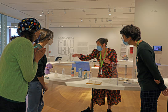A small group taking an interactive tour of the Designing Motherhood exhibition.