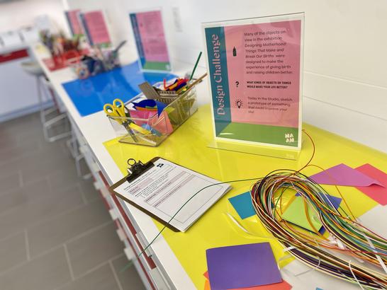 Artmaking materials set up for a drop-in design challenge activity.