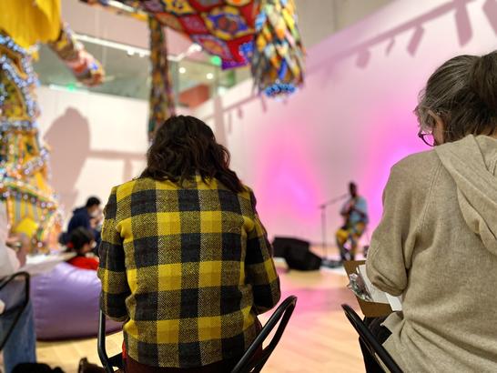 Visitors sketching in the Paine Gallery while listening to music.