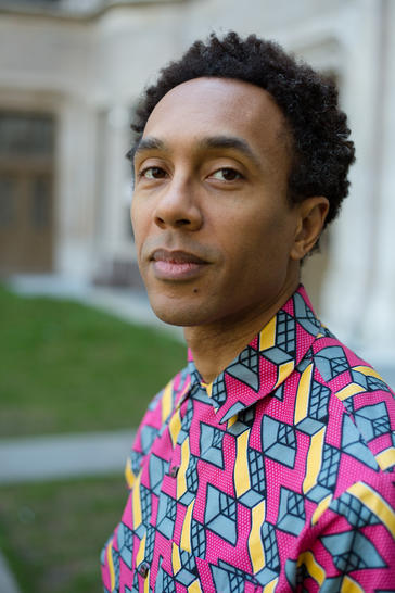 portrait of Jace Clayton wearing a brightly colored and patterned shirt