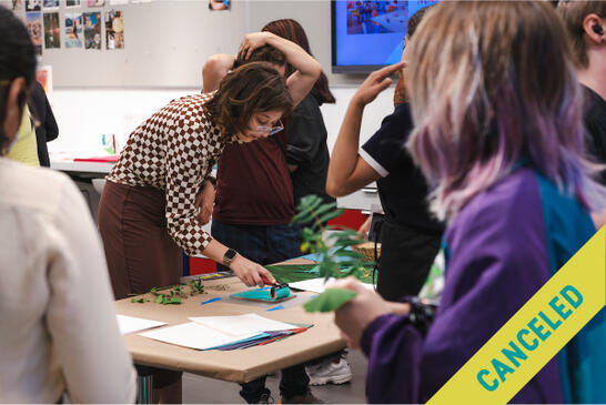 A woman demonstrates an art project to a group; CANCELED is written diagonally across the image.