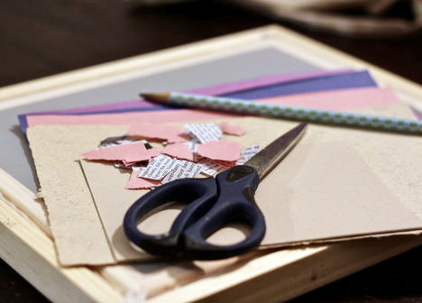 photograph of torn paper, scissors, and pencil.