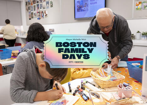 Children and adults do crafts at a table; a sign reads Boston Family Days, City of Boston.