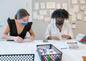 Two visitors making artwork in the MAAM Barkan Big Ideas Studio