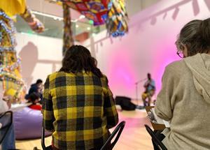 Visitors sketching in the Paine Gallery while listening to music.