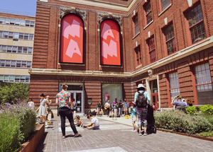 Visitors gather on the MAAM plaza to hear live music and draw with sidewalk chalk