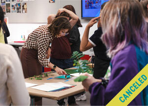 A woman demonstrates an art project to a group; CANCELED is written diagonally across the image.