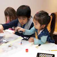 Two children making artwork.