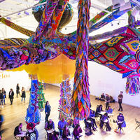 People gather and sketch under Joana Vasconcelos' huge sculptural installation.