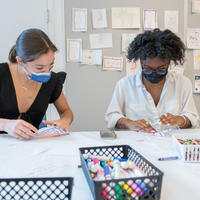 Two visitors making artwork in the MAAM Barkan Big Ideas Studio