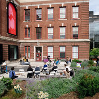 Visitors sketching in MAAM's outdoor plaza.