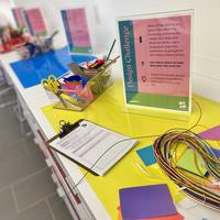 Artmaking materials set up for a drop-in design challenge activity.