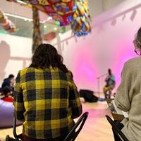 Visitors sketching in the Paine Gallery while listening to music.