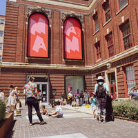Visitors gather on the MAAM plaza to hear live music and draw with sidewalk chalk