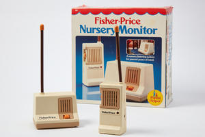 A 1983 baby monitor and box on a white background.