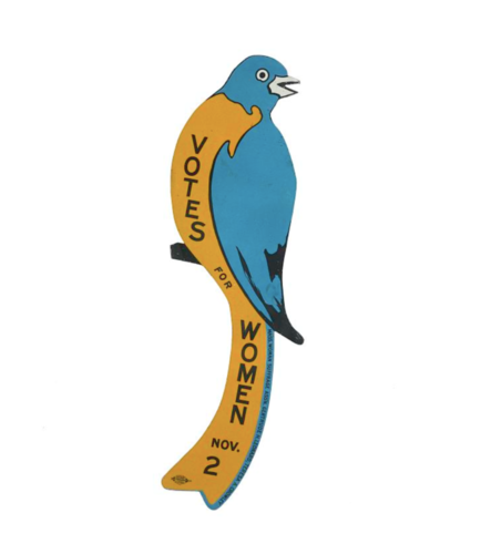Historic image of a suffage bluebird. A cut out blue bird sitting on a branch with a yellow belly with the text "Votes for Women. Nov. 2"