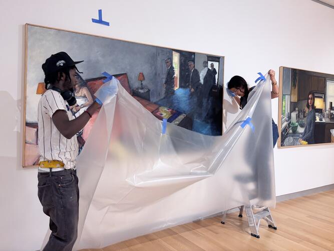 MAAM Catalyst Fellow Sebastian (left) assisting with the installation of the exhibition, GENERATIONS. 
