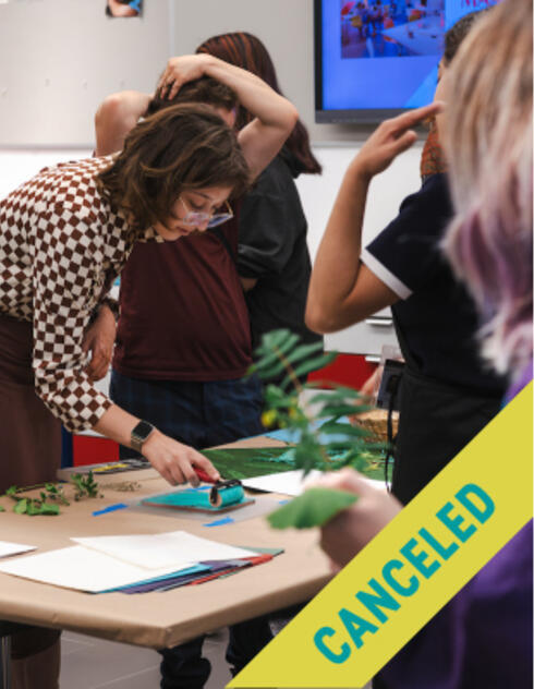 Woman uses roller on paper at a craft table with others, overlaid with a large yellow CANCELED label.
